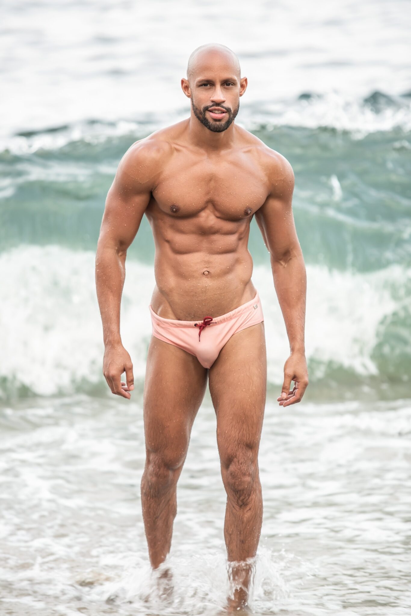 latin bald muscle hunk harold lopez lucasentertainment shaved head smooth muscle beach in waves