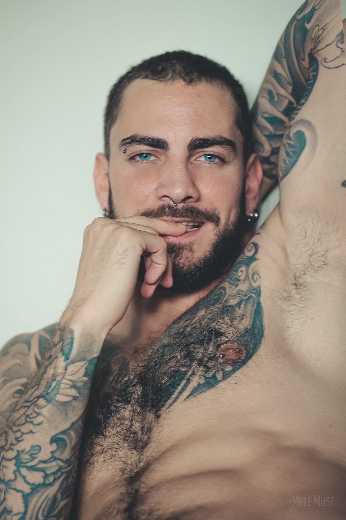 Hairy Muscle Hunk With Piercing blue eyes Marc From The Male Muse biting his lips